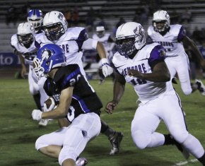 Defensive standout Kelechi Ndoh puts a big hit on a Huskie Thursday night in Neighbor Bowl.